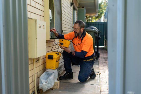 Electrician working on an outdoor electrical meter box