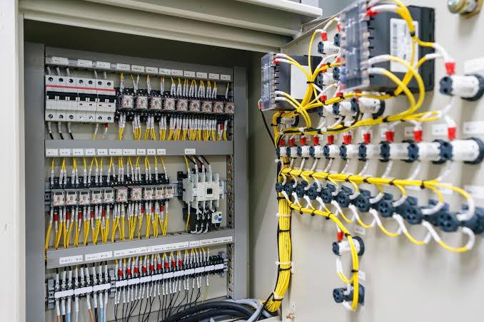 Industrial electrical panel with breakers and yellow wiring